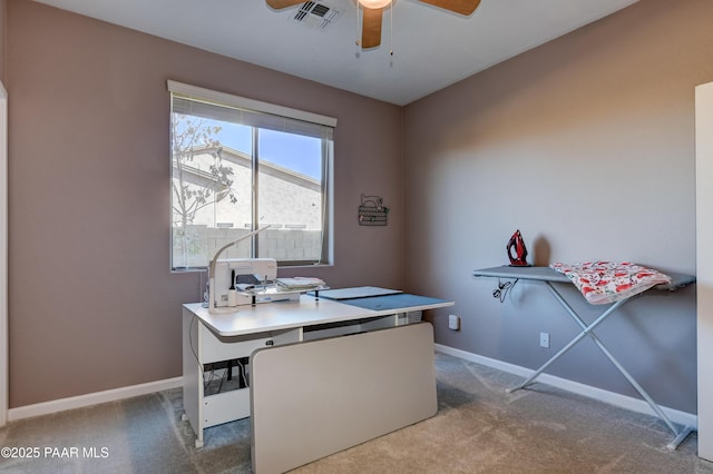 carpeted home office with ceiling fan