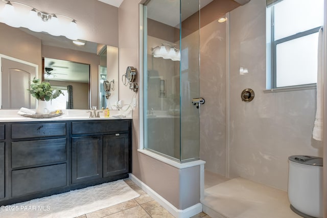 bathroom featuring vanity, ceiling fan, walk in shower, and tile patterned flooring