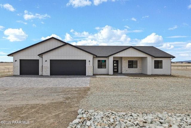 6829 E Sapphire Ln, Prescott Valley, AZ 86315 - modern farmhouse featuring a garage, decorative driveway, stone siding, and a shingled roof