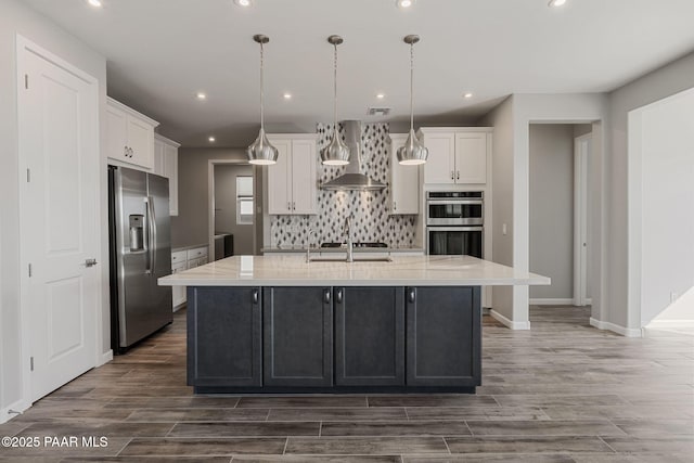 5268 Tranquil Bluff Way, Prescott, AZ 86301 - kitchen with appliances with stainless steel finishes, wall chimney exhaust hood, white cabinets, tasteful backsplash, and dark wood finished floors