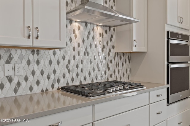 5268 Tranquil Bluff Way, Prescott, AZ 86301 - kitchen featuring wall chimney range hood, stainless steel appliances, white cabinets, and light countertops