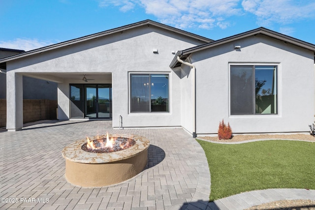 5268 Tranquil Bluff Way, Prescott, AZ 86301 - rear view of property featuring a patio area, an outdoor fire pit, stucco siding, and a lawn