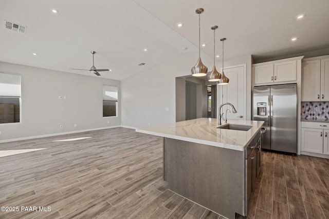 5268 Tranquil Bluff Way, Prescott, AZ 86301 - kitchen with stainless steel fridge, a sink, light wood-style floors, ceiling fan, and a center island with sink
