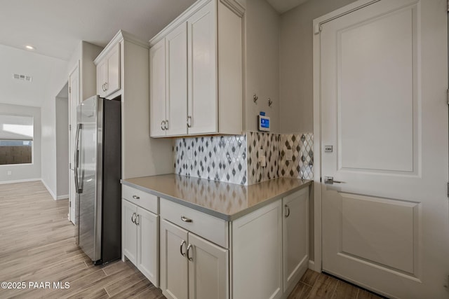 5268 Tranquil Bluff Way, Prescott, AZ 86301 - kitchen featuring freestanding refrigerator, light wood finished floors, tasteful backsplash, white cabinets, and recessed lighting
