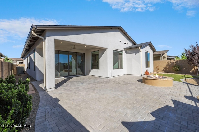 5268 Tranquil Bluff Way, Prescott, AZ 86301 - rear view of property featuring stucco siding, a fenced backyard, ceiling fan, a fire pit, and a patio area