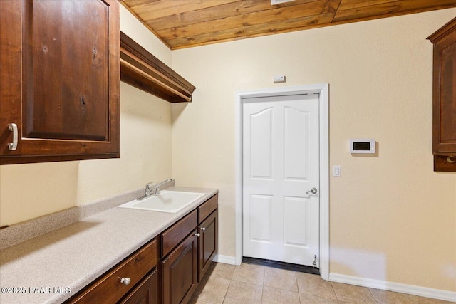 washroom featuring light tile patterned flooring, sink, and wood ceiling