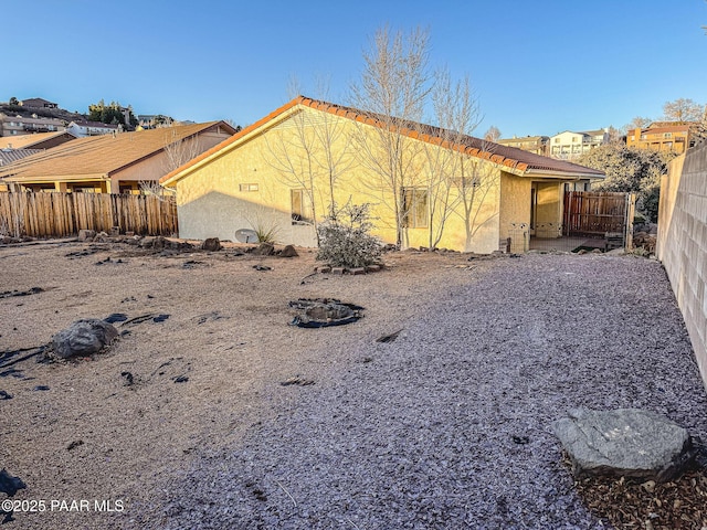 view of home's exterior featuring a patio area, fence, and stucco siding