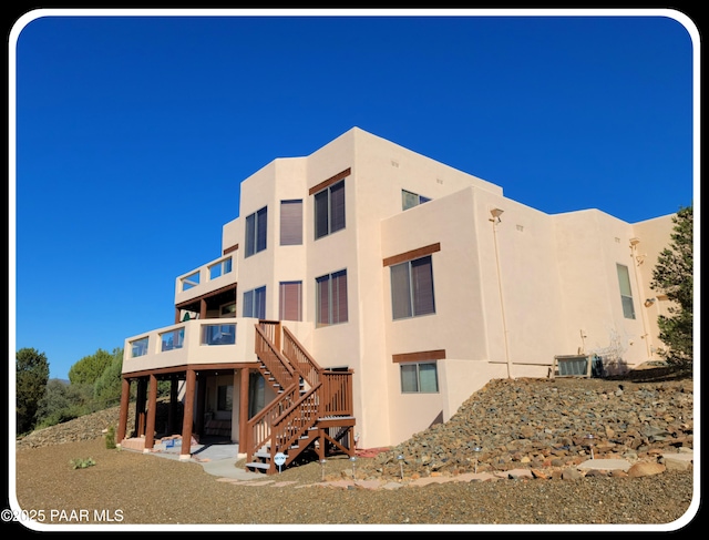 10614 E High Point Dr, Dewey-Humboldt, AZ 86327 - view of building exterior featuring stairway and central AC