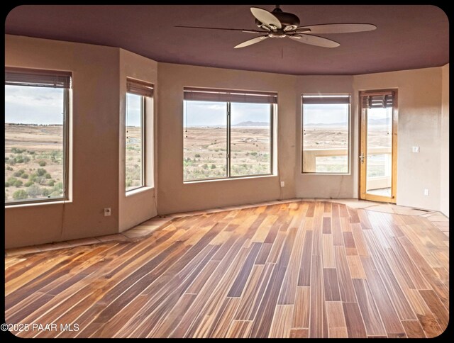 10614 E High Point Dr, Dewey-Humboldt, AZ 86327 - spare room featuring ceiling fan, wood finished floors, and plenty of natural light