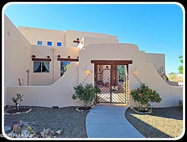 10614 E High Point Dr, Dewey-Humboldt, AZ 86327 - property entrance featuring a gate and stucco siding