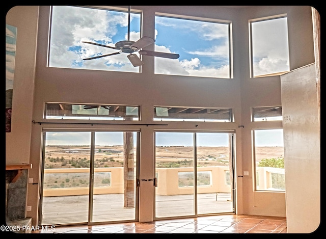 10614 E High Point Dr, Dewey-Humboldt, AZ 86327 - doorway featuring tile patterned flooring, plenty of natural light, ceiling fan, and a high ceiling