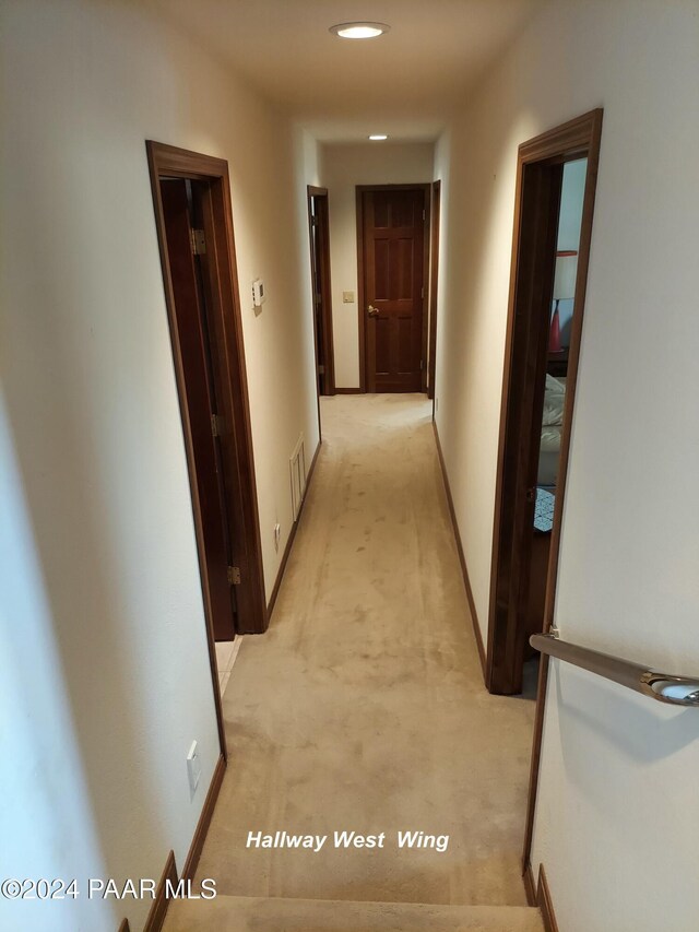 corridor with light colored carpet