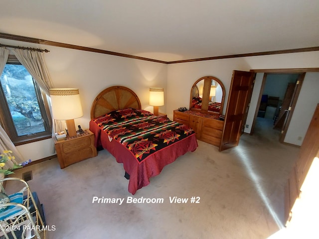 carpeted bedroom with ornamental molding and baseboards