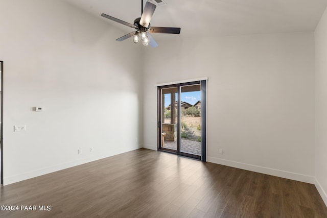 unfurnished room with dark hardwood / wood-style flooring, high vaulted ceiling, and ceiling fan