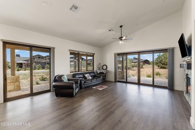 living room featuring ceiling fan, dark wood-type flooring, and high vaulted ceiling