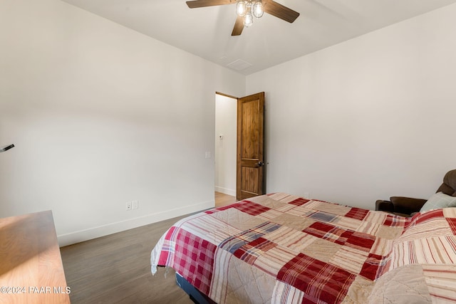 bedroom with ceiling fan and dark hardwood / wood-style flooring