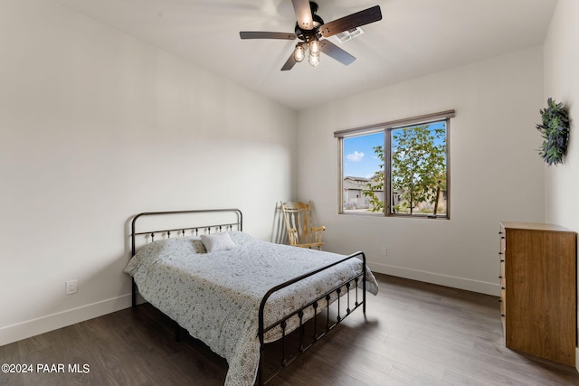 bedroom with ceiling fan and dark wood-type flooring