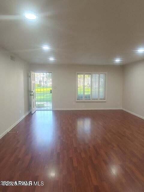 spare room with dark hardwood / wood-style floors