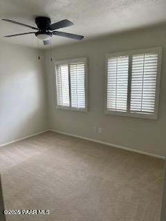 carpeted empty room with ceiling fan