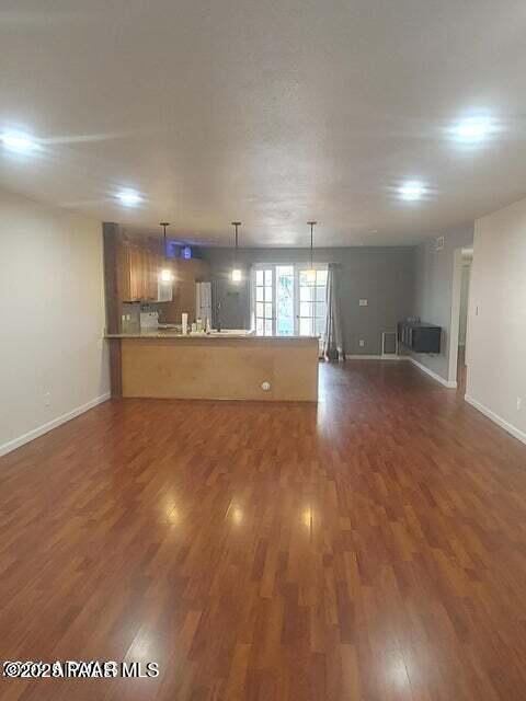 unfurnished living room with dark hardwood / wood-style flooring