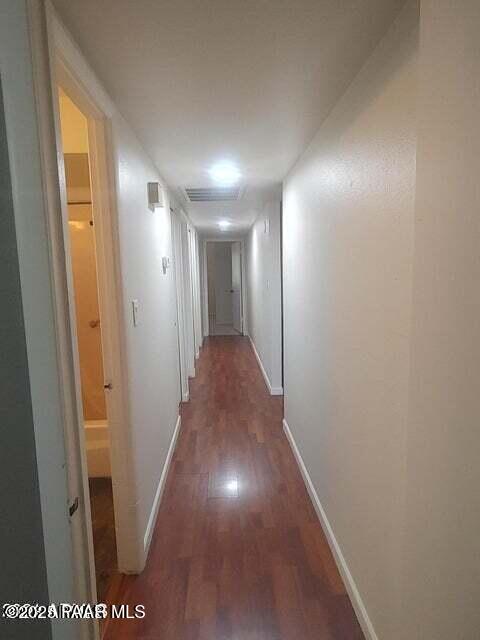 hallway with dark wood-type flooring