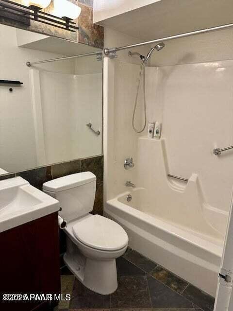 full bathroom with shower / tub combination, vanity, and toilet