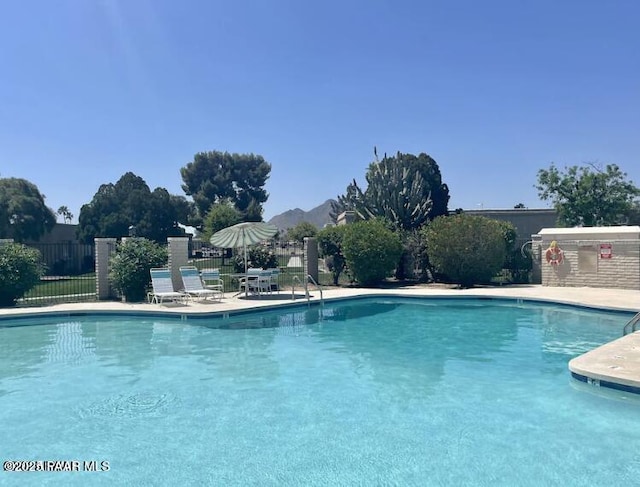 view of pool featuring a mountain view and a patio