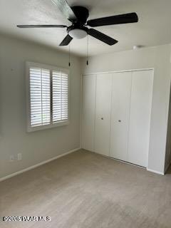 unfurnished bedroom with a closet and ceiling fan