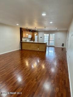 unfurnished living room with dark hardwood / wood-style floors