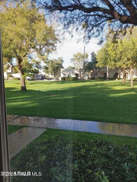 view of home's community featuring a yard