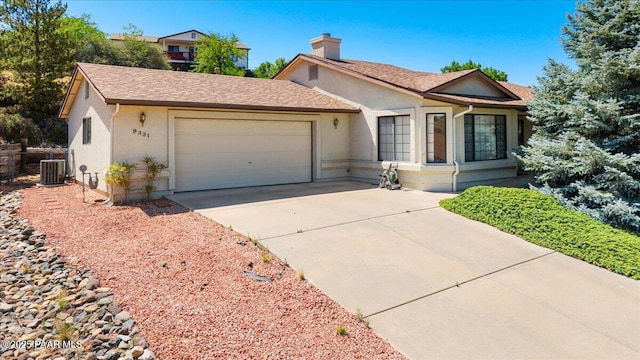 9331 Serpentine Ln, Prescott Valley, AZ 86314 - ranch-style home with a garage, concrete driveway, stucco siding, and a chimney