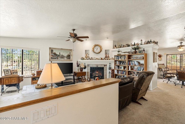 9331 Serpentine Ln, Prescott Valley, AZ 86314 - living room featuring ceiling fan, a textured ceiling, carpet, and a fireplace