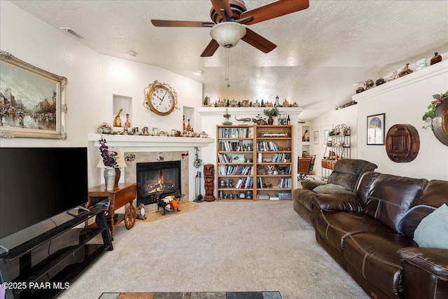9331 Serpentine Ln, Prescott Valley, AZ 86314 - carpeted living area featuring a fireplace, ceiling fan, a textured ceiling, and vaulted ceiling