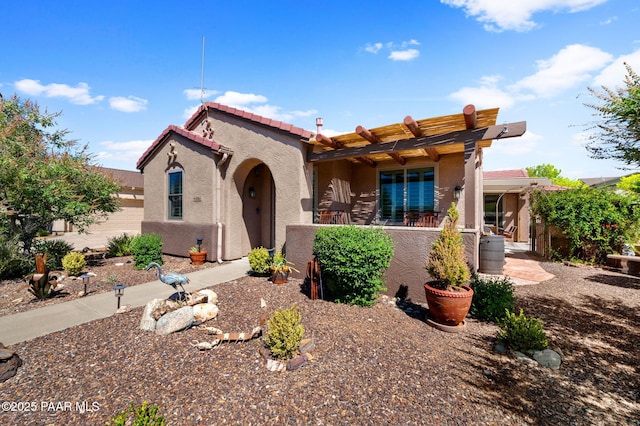 view of front facade featuring stucco siding and a tile roof