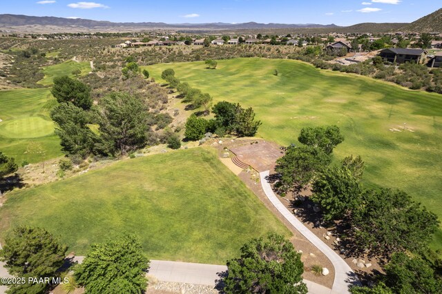 drone / aerial view featuring golf course view and a mountain view