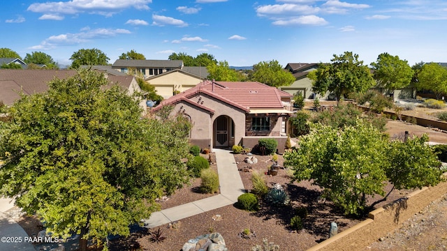 view of front of home with stucco siding and a tiled roof