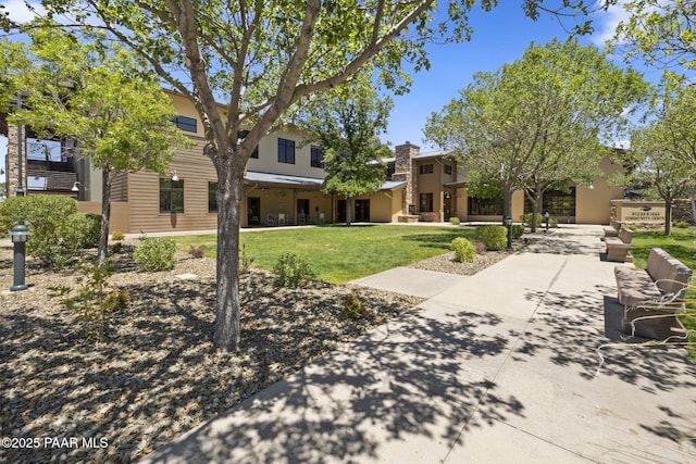 view of home's community with a yard