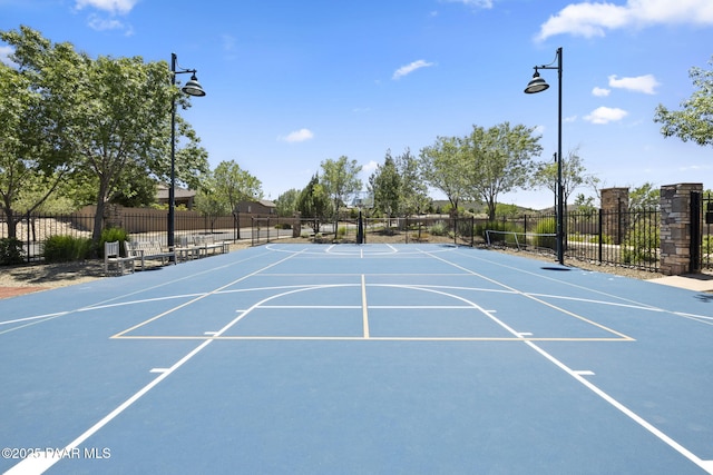 view of community with community basketball court and fence