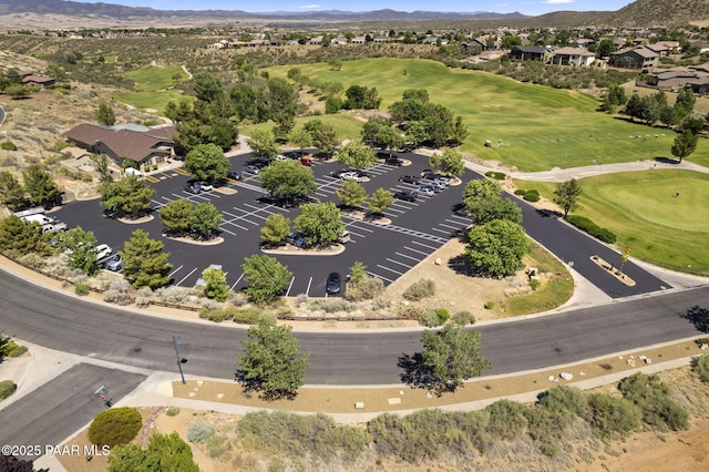 drone / aerial view with a mountain view and view of golf course