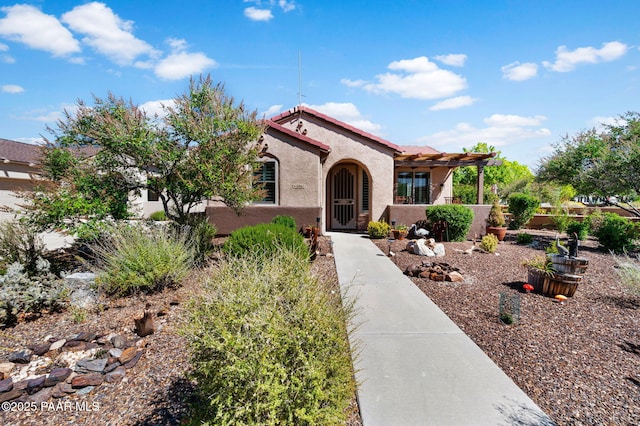 view of front of house with stucco siding and a tile roof