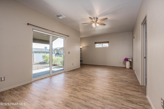 unfurnished room featuring ceiling fan, baseboards, and wood finished floors