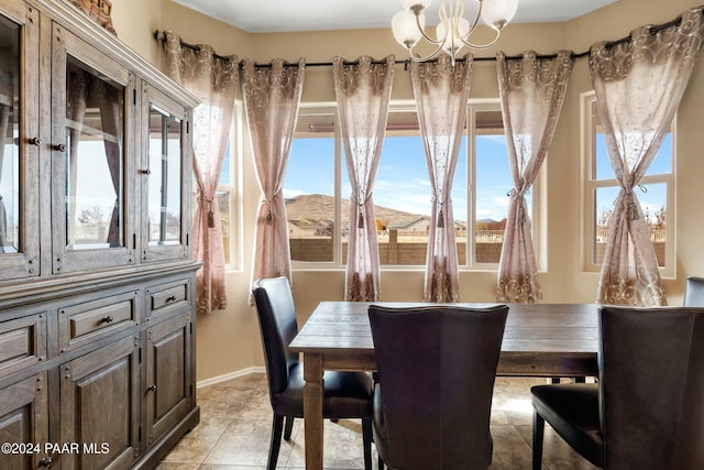 tiled dining area with a mountain view and an inviting chandelier