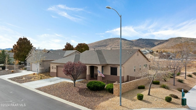 view of front of home featuring a mountain view and a garage