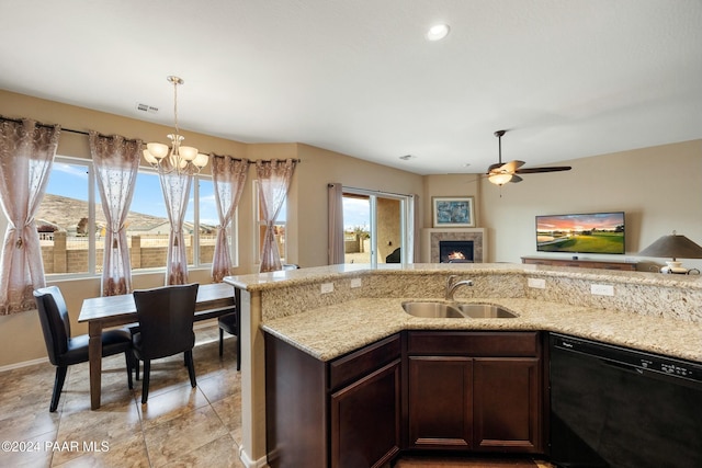 kitchen featuring a healthy amount of sunlight, sink, dark brown cabinetry, and black dishwasher