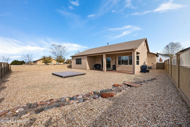 back of property featuring solar panels