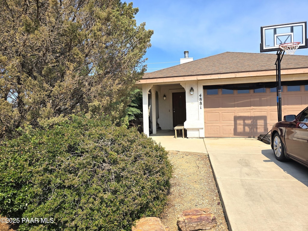 4881 N Tonto Way, Prescott Valley, AZ 86314 - ranch-style home featuring a garage, concrete driveway, a shingled roof, and stucco siding