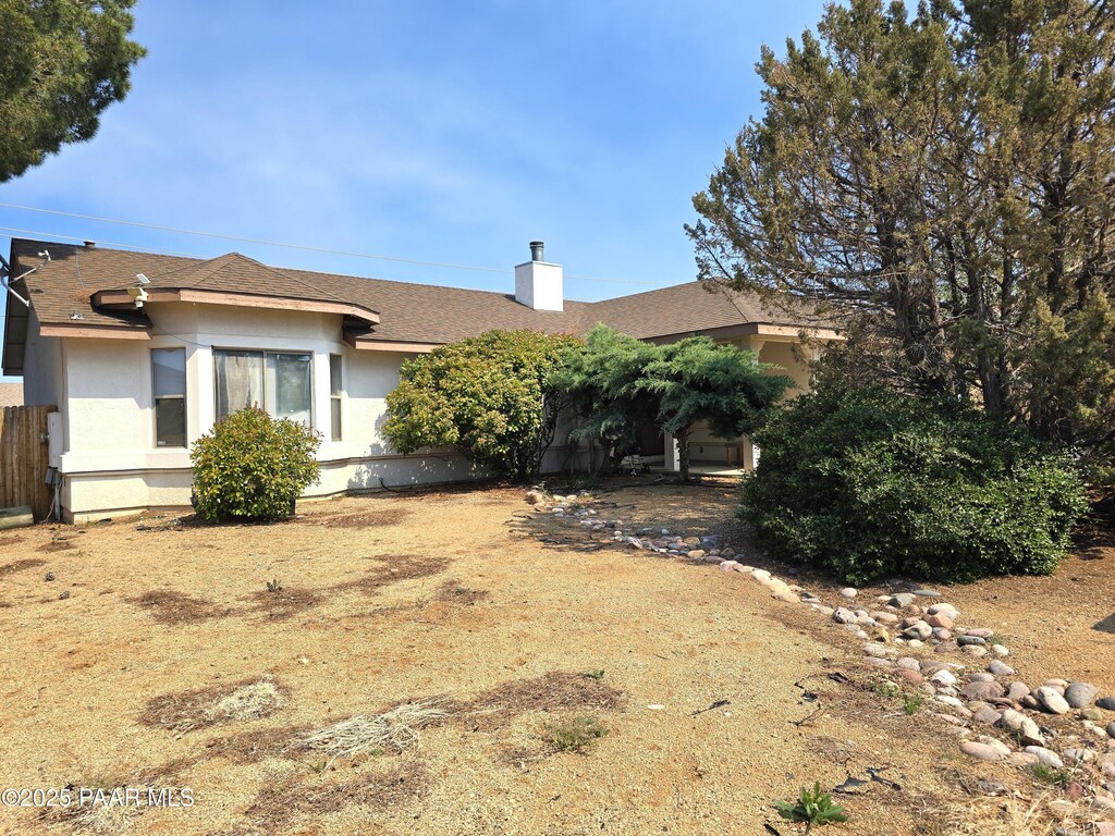4881 N Tonto Way, Prescott Valley, AZ 86314 - view of front of house with stucco siding and a chimney