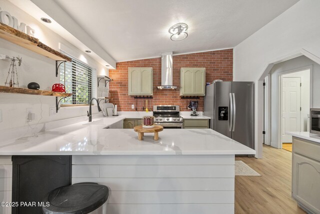 4361 N Covina Cir, Prescott Valley, AZ 86314 - kitchen featuring stainless steel appliances, wall chimney exhaust hood, a peninsula, open shelves, and light countertops