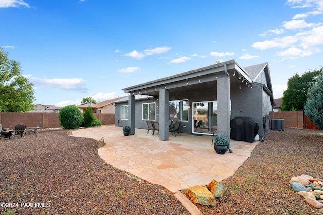 rear view of property featuring a patio area and central AC unit