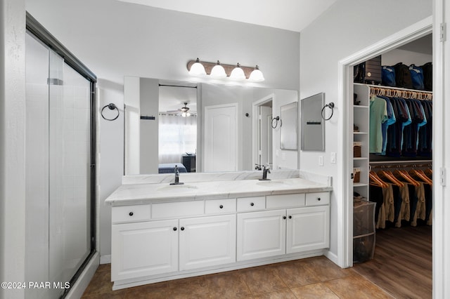 bathroom featuring vanity, ceiling fan, wood-type flooring, and a shower with shower door